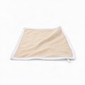 A square beige mesh bag with a white zipper and white trim, shown on a plain white background.